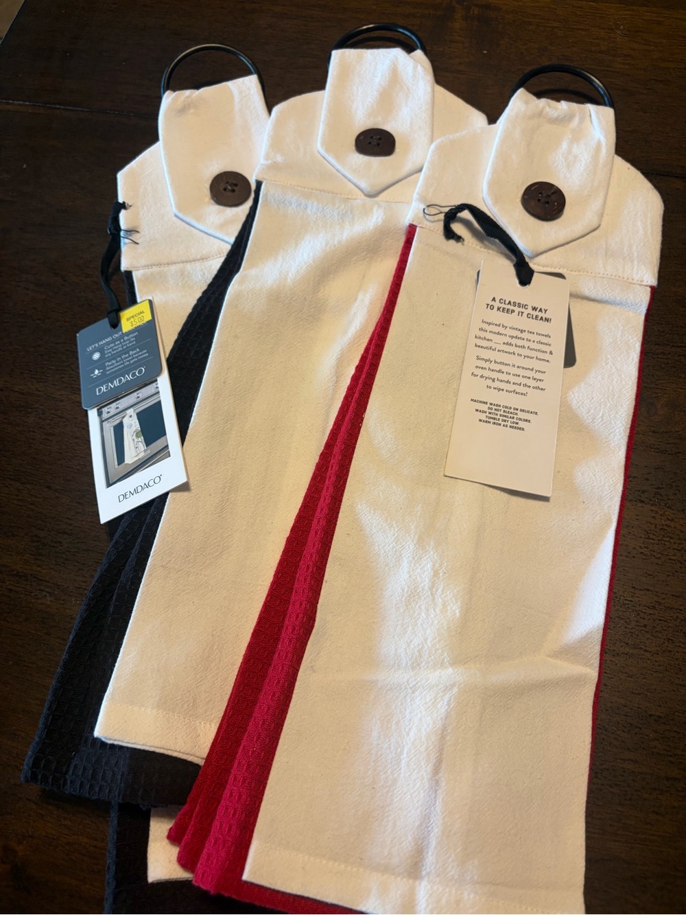 Demdaco hand towels - White with Red and white with black. 3 sets total.